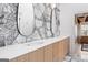 Bathroom featuring double sinks, sleek mirrors, modern fixtures, and hardwood floors at 612 Champions Dr, Mcdonough, GA 30253