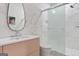 Modern bathroom featuring sleek vanity, minimalist mirror, and glass-enclosed shower at 612 Champions Dr, Mcdonough, GA 30253