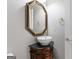 Stylish powder room featuring a vessel sink and ornate framed mirror at 612 Champions Dr, Mcdonough, GA 30253