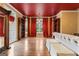 A sunlit bedroom is accentuated with a red ceiling and gleaming hardwood floors at 612 Champions Dr, Mcdonough, GA 30253