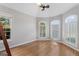 Bedroom featuring vaulted ceiling, hardwood floors and arched windows with shutters at 612 Champions Dr, Mcdonough, GA 30253