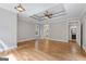 Expansive bedroom with tray ceiling, hardwood floors, and ensuite bathroom entrance at 612 Champions Dr, Mcdonough, GA 30253
