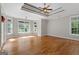 Spacious bedroom with hardwood floors, tray ceiling, and lots of windows at 612 Champions Dr, Mcdonough, GA 30253