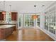 Sunlit breakfast nook features hardwood floors and large windows providing serene views at 612 Champions Dr, Mcdonough, GA 30253