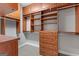 Walk-in closet featuring custom shelving and wooden drawers at 612 Champions Dr, Mcdonough, GA 30253