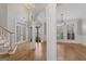 Spacious foyer features hardwood floors, staircase, and decorative glass front door at 612 Champions Dr, Mcdonough, GA 30253