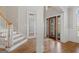 Bright foyer featuring hardwood floors, staircase, glass front door and sidelights at 612 Champions Dr, Mcdonough, GA 30253