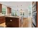 Open kitchen with granite counters, wooden cabinetry, and views of breakfast nook at 612 Champions Dr, Mcdonough, GA 30253