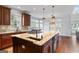 Spacious kitchen island with a built-in cooktop and sink, perfect for meal preparation and entertaining at 612 Champions Dr, Mcdonough, GA 30253