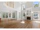 Spacious living room with hardwood floors, soaring ceilings, fireplace, and abundant natural light at 612 Champions Dr, Mcdonough, GA 30253