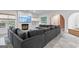 Large, comfortable gray sectional sofa centers the living room, complemented by a fireplace and stylish wall art at 612 Champions Dr, Mcdonough, GA 30253