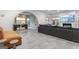 Spacious living room with modern gray sectional sofa, arched doorways, and decorative lighting fixture above the dining table at 612 Champions Dr, Mcdonough, GA 30253