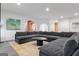 Expansive living room showcases a plush gray sectional sofa, modern black coffee table, and contemporary decor at 612 Champions Dr, Mcdonough, GA 30253