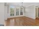 Bright room boasts hardwood floors, classic trim, modern lighting, and large windows at 612 Champions Dr, Mcdonough, GA 30253