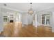 Open living room showcasing hardwood floors, and a fireplace with architectural details at 612 Champions Dr, Mcdonough, GA 30253