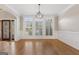Sunlit living room featuring hardwood floors, classic trim and windows with shutters at 612 Champions Dr, Mcdonough, GA 30253