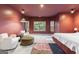 Light and airy primary bedroom with comfortable seating area and large windows offering scenic views at 612 Champions Dr, Mcdonough, GA 30253