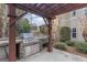 Outdoor kitchen with built-in grill, sink and stone counter tops at 612 Champions Dr, Mcdonough, GA 30253