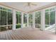 Screened-in porch with wood flooring and views of wooded backyard at 612 Champions Dr, Mcdonough, GA 30253