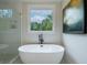 Modern soaking tub and frameless glass shower offer tranquil bathroom views at 3785 Pilgrim Mill Rd, Cumming, GA 30041