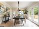 Bright dining room with modern light fixture, table and seating for six, and a large piece of abstract art at 3785 Pilgrim Mill Rd, Cumming, GA 30041