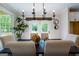 Dining room with table, seating for six, modern lighting, and a view to the wooded back yard at 3785 Pilgrim Mill Rd, Cumming, GA 30041