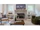 Lovely stone fireplace with decor, hardwood floors, and natural light from nearby windows at 3785 Pilgrim Mill Rd, Cumming, GA 30041