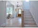 Bright foyer with hardwood floors, stairs to the second floor, and view of the living room at 3785 Pilgrim Mill Rd, Cumming, GA 30041