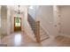 Lovely foyer with hardwood floors, staircase with black iron spindles, and wooden front door at 3785 Pilgrim Mill Rd, Cumming, GA 30041