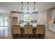 Bright kitchen with white cabinets, gray backsplash, large island with seating, and stainless steel appliances at 3785 Pilgrim Mill Rd, Cumming, GA 30041