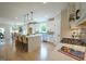 Bright open kitchen with an island, stainless steel appliances, and modern pendant lighting creates a focal point at 3785 Pilgrim Mill Rd, Cumming, GA 30041