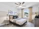 Charming bedroom featuring neutral tones, carpeted floor, ceiling fan, and a decorative airplane art piece at 120 Aj Welch Jr Way, Mcdonough, GA 30252