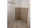 Neutral colored bathroom wall-tile, mosaic tile flooring, white door and white trim molding at 103 Emory Way, Oxford, GA 30054