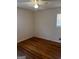Clean, bright bedroom featuring a ceiling fan, window, and handsome wood flooring at 103 Emory Way, Oxford, GA 30054