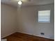 Cozy bedroom showcasing natural light, ceiling fan and attractive wood flooring at 103 Emory Way, Oxford, GA 30054