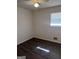 Bright bedroom featuring a ceiling fan, window with blinds, and attractive dark wood-look flooring at 103 Emory Way, Oxford, GA 30054