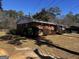 Well-kept brick home features red shutters, a paved driveway, and an attached one-car garage at 103 Emory Way, Oxford, GA 30054