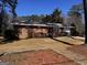 Charming brick home with red shutters, a well-maintained lawn, and a convenient attached garage at 103 Emory Way, Oxford, GA 30054