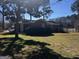 Well maintained front yard with healthy lawn and mature shrubs framing a single story brick home at 103 Emory Way, Oxford, GA 30054