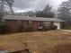 Charming one-story brick home featuring an attached garage and a well-maintained front yard at 103 Emory Way, Oxford, GA 30054