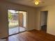 Living area with hardwood floors, sliding glass doors to the backyard, and access to another room at 103 Emory Way, Oxford, GA 30054