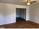 Open-concept living area with hardwood flooring leading into an adjacent room with darker flooring at 103 Emory Way, Oxford, GA 30054