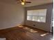 Bright room with hardwood floors, large windows with blinds, and a ceiling fan at 103 Emory Way, Oxford, GA 30054