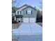 Two-story home with a two-car garage and a well-maintained front lawn at 7522 Springbox Dr, Fairburn, GA 30213