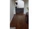 Hallway with wooden floors, leading to a living room with couch and fireplace at 7522 Springbox Dr, Fairburn, GA 30213