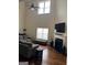 Bright living room with tall ceilings, fireplace, and wood floors at 7522 Springbox Dr, Fairburn, GA 30213