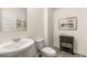 Stylish powder room with pedestal sink, decorative mirror, and neutral color scheme at 5429 Flat Rock Point # 1, Stonecrest, GA 30038