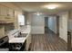 Well-lit kitchen featuring laminate flooring and a double stainless steel sink at 2691 Old South Dr, Jonesboro, GA 30236