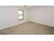 Bedroom featuring neutral carpet, a black frame window, and base molding at 1314 N Lea Se Ct, Smyrna, GA 30080