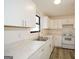 Bright kitchen features white cabinets and modern marble-look countertops, plus stainless sink at 1314 N Lea Se Ct, Smyrna, GA 30080